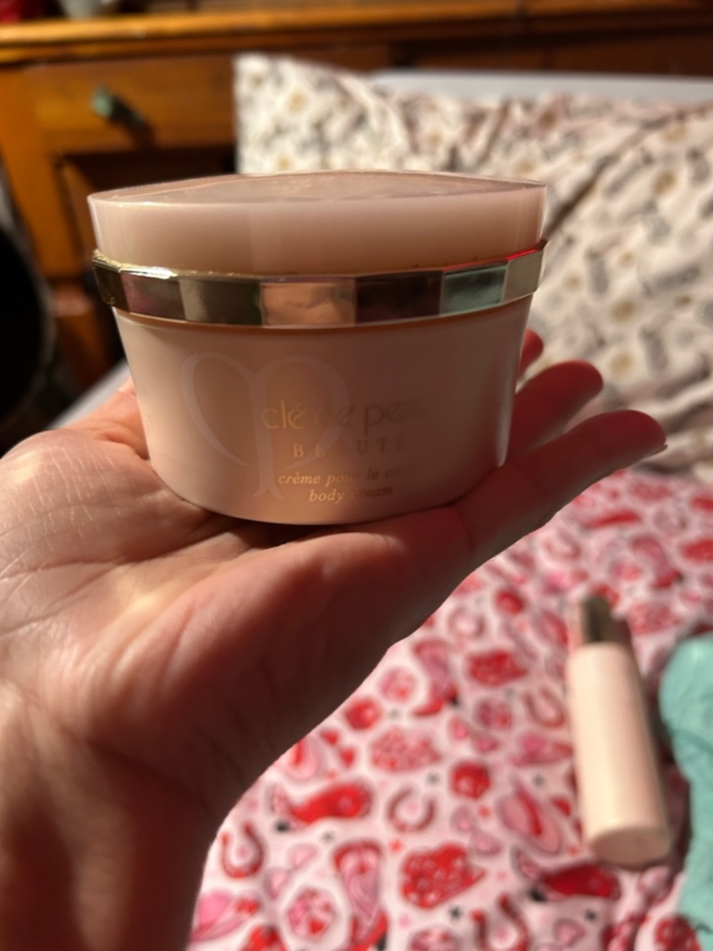 cle de peau pink and gold body cream jar
